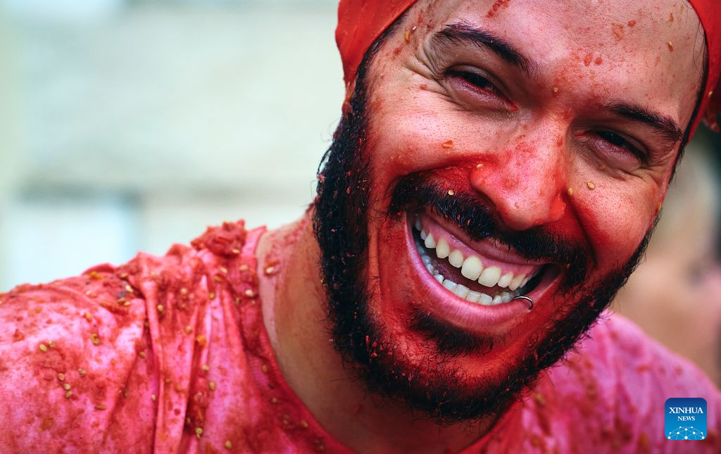 A reveller is pictured during the annual tomato fight (La Tomatina) in Bunol near Valencia, Spain, Aug. 26, 2026. (Photo by Pablo Morano/Xinhua)