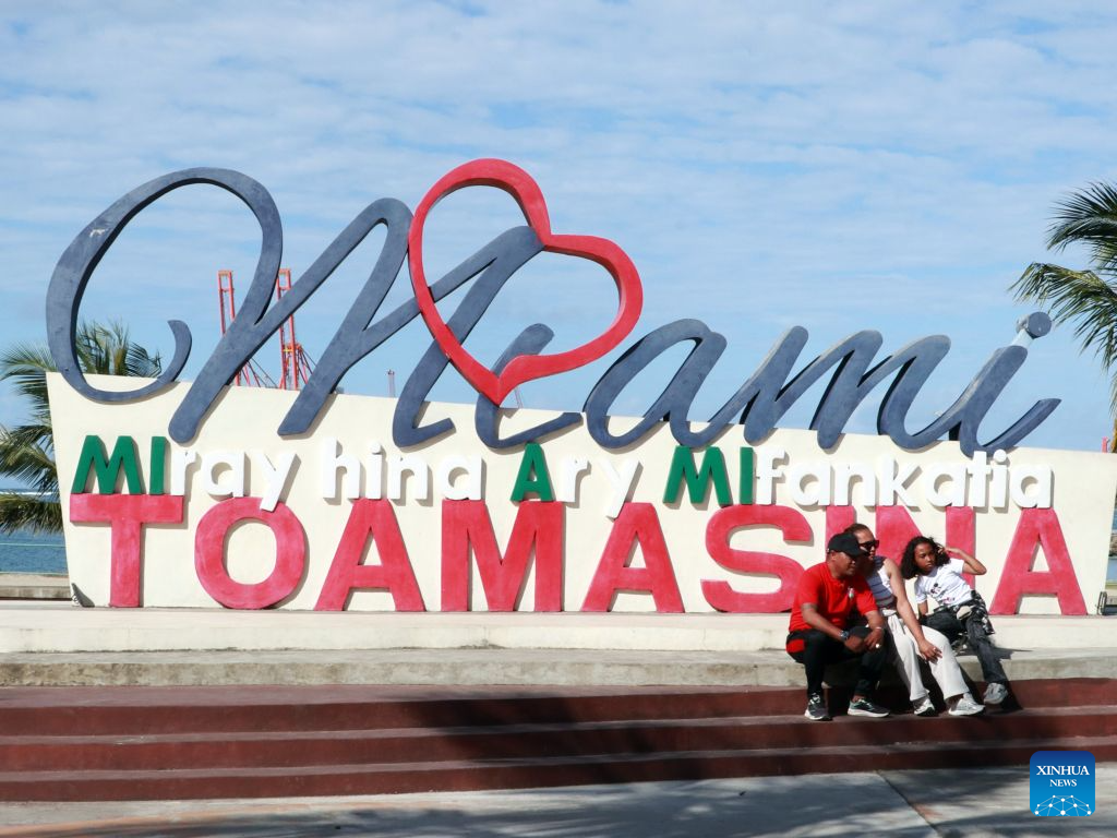 People pose for photos near the Port of Toamasina in Toamasina, eastern Madagascar, Aug. 8, 2026. Toamasina is a major port city on Madagascar's east coast. (Xinhua/Chen Shaohua)