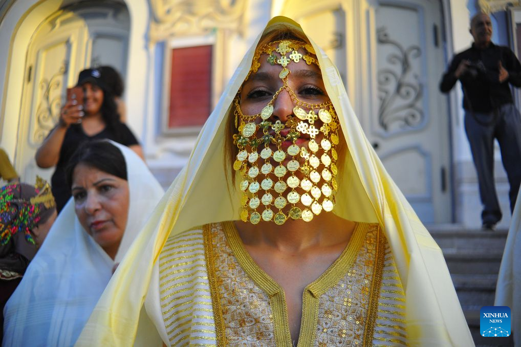 A Tunisian woman in traditional costumes is pictured during the celebration of the annual National Women's Day in Tunis, Tunisia, Aug. 13, 2026. (Photo by Adel Ezzine/Xinhua)