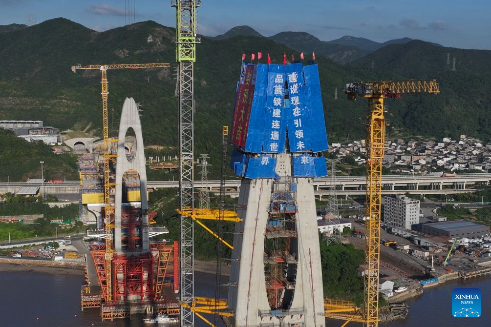 An aerial drone photo taken on Sept. 12, 2026 shows the construction site of the No. 20 main tower of Fuchimen road-rail bridge along Ningbo-Zhoushan Railway in Zhoushan, east China's Zhejiang Province. The main tower, constructed by the China Railway Major Bridge Engineering Group Co., Ltd., was successfully topped out on Sunday, marking the completion of the construction of all six main towers of the three cross-sea bridges of the Ningbo-Zhoushan Railway.

The main line of the Ningbo-Zhoushan Railway is 76.4 kilometers long, starting from Ningbo East Railway Station in the west and ending at Zhoushan Island in the east, with a designed speed of 250 kilometers per hour. (Xinhua/Huang Zongzhi)