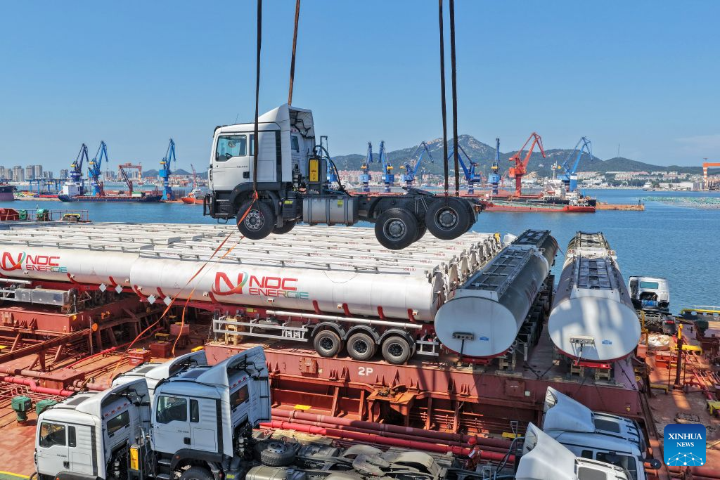 A drone photo taken on Aug. 16, 2026 shows China-produced trucks bound for Ghana being loaded onto a ship at Yantai Port in east China's Shandong Province. Yantai Port's general cargo shipment volume to Africa has exceeded 6 million tonnes since the beginning of this year, a year-on-year increase of 66.1 percent. (Photo by Tang Ke/Xinhua)