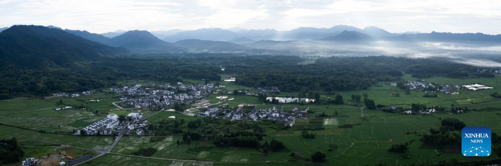 A stitched aerial drone photo taken on July 8, 2026 shows the view of Shi Ting Village in Yixian County, east China's Anhui Province. The ancient village of Shi Ting, located in the north of Yixian County in east China's Anhui Province, boasts of beautiful natural scenery and profound cultural heritage. (Xinhua/Jin Liwang)