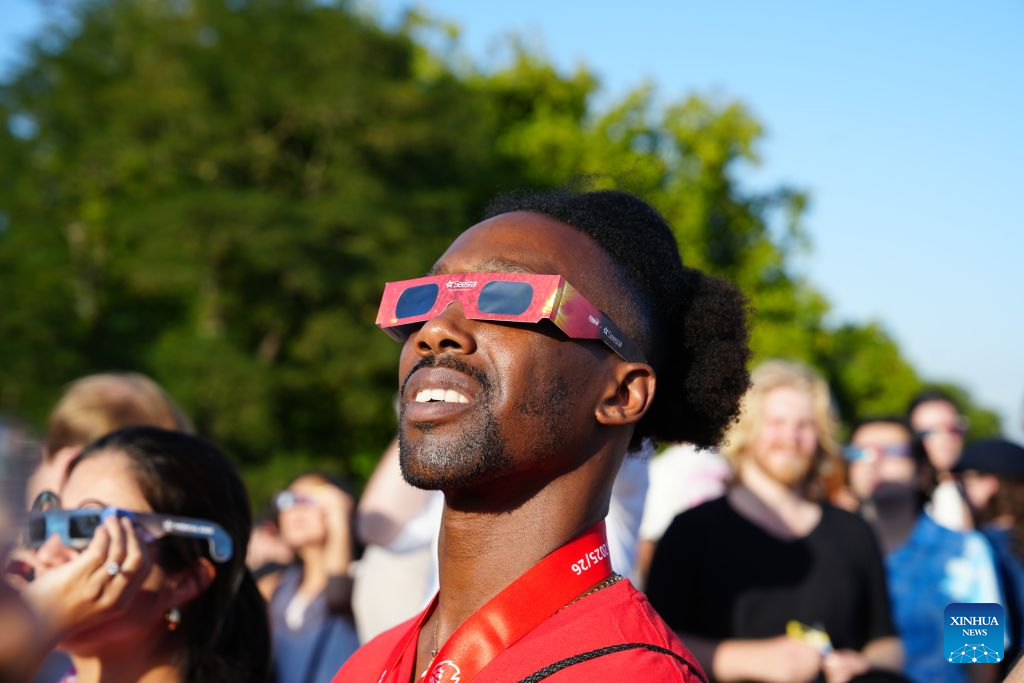 People observe the partial solar eclipse on Primrose Hill in London, Britain, Aug. 12, 2026. (Xinhua/Zhang Feng)