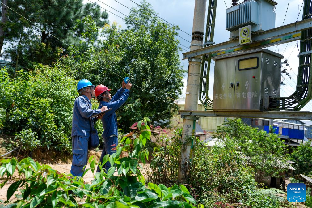 Power grid workers check power facilities at a temporary shelter at Jingping Village in Yutang Town of Mojiang Hani Autonomous County, southwest China's Yunnan Province, on July 22, 2026. The Yunnan provincial earthquake relief headquarters has activated a Level-IV emergency response after a 5.0-magnitude earthquake jolted Mojiang on Tuesday, local authorities said. No casualties have been reported so far. (Xinhua/Chen Xinbo)