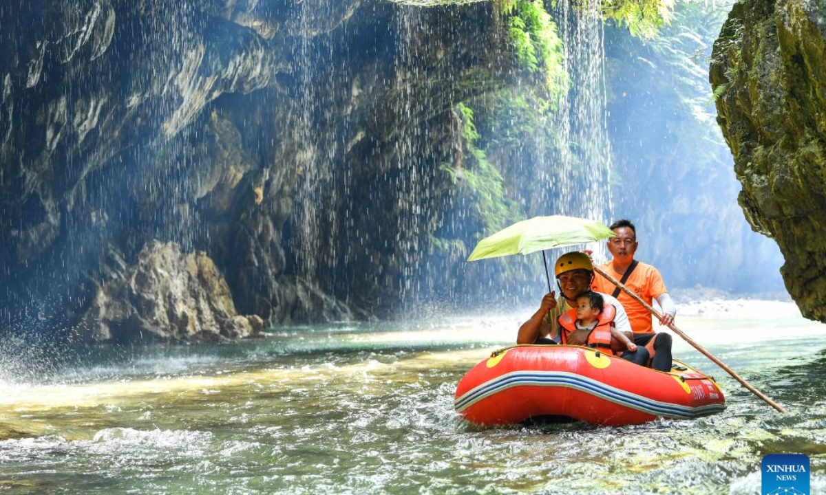 Tourists enjoy rafting at a scenic area in Huangping County, southwest China's Guizhou Province, July 29, 2026. During the summer vacation, Huangping has leveraged its mountain springs and canyon landscapes to develop a rafting tourism brand, attracting visitors for a refreshing getaway while boosting local tourism and incomes. (Xinhua/Yang Wenbin)