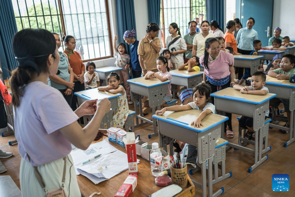 Students and their parents are pictured at a school in Bo'ai Town of Funing County, Wenshan Zhuang and Miao Autonomous Prefecture, southwest China's Yunnan Province, Aug. 30, 2026. Bo'ai Town in Funing County is surrounded by mountains, with rough roads and many rivers. For many years, students from nearby villages had a difficult trip to school. They either traveled on mountain roads by vehicle or crossed rivers on privately run boats to arrive at schools in the town.

Since 2021, local authorities have worked together to provide free ferry services for students. Seven water school buses now run regularly at 12 ferry crossings in the town, taking students to and from school at different time according to their school schedules.

Today, 329 students in Bo'ai Town use the ferry services. Since 2021, the service has carried students on more than 147,000 trips. (Xinhua/Wang Guansen)