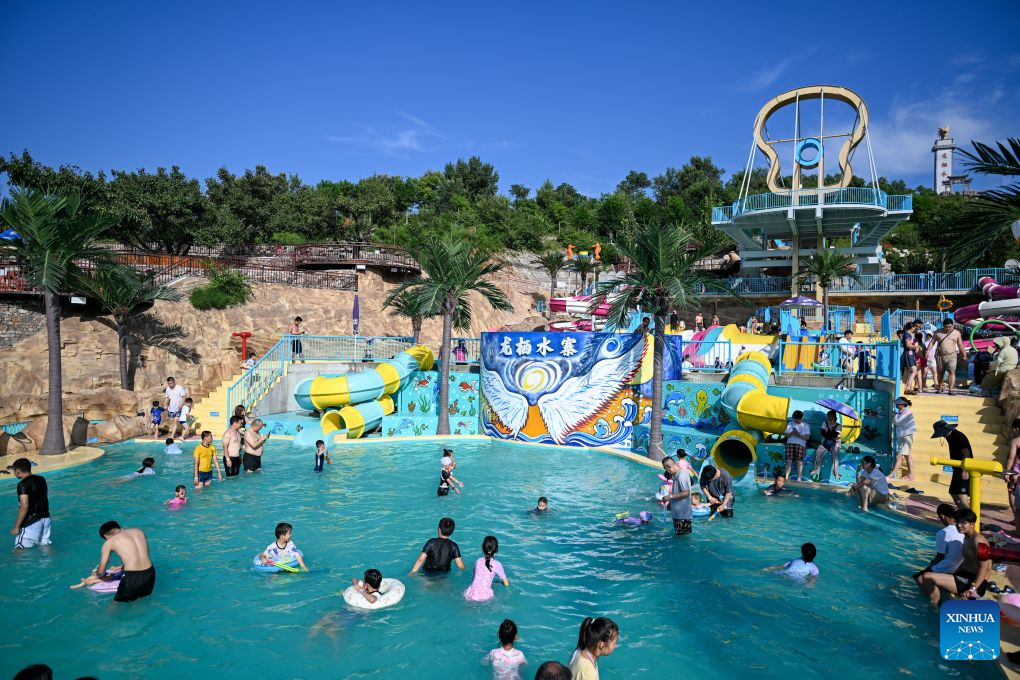 Tourists play at a water park in Tianjin, north China, Aug. 4, 2026. (Xinhua/Sun Fanyue)