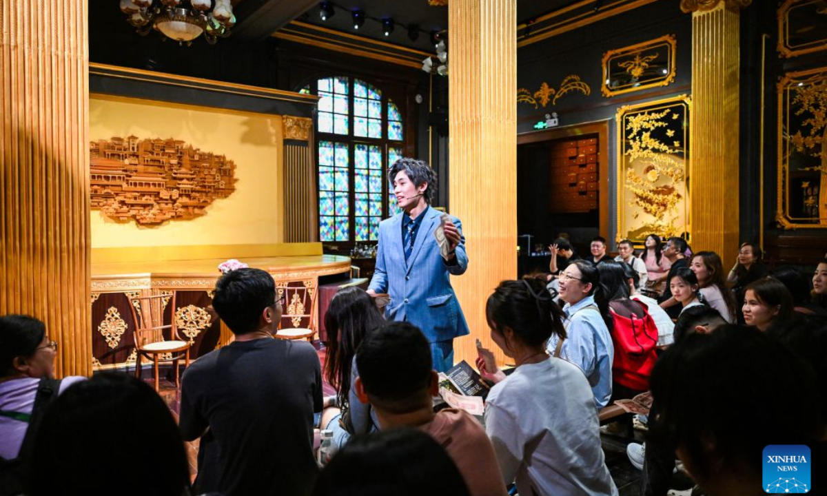 An actor of an immersive drama interacts with the audience at the former site of L'indo Bank of China in Tianjin, north China, Sept. 27, 2026. Built in 1912, the former site of L'indo Bank of China is one of the landmarks in Tianjin's Jiefang North Road historical and cultural block, witnessing the development of the city's financial industry in modern times.
This building had undergone many historical changes and had been used successively as an art museum, an international auction house, and a museum of Western art. However, due to the scarcity of exhibitions, it had been idle for a long time until the latest renovation.
In 2025, Beijing Performance & Arts Group, together with Tianjin North Performing Arts Group, initiated the revitalization of the building, creating an immersive performance scene while preserving its original appearance.
This April, the newly renovated building was officially opened to the public, and visitors can view a live-action exhibition here during the day and watch an immersive drama at night.
Up to now, the renovated building has received approximately 30,000 visitors. (Xinhua/Zhao Zishuo)
