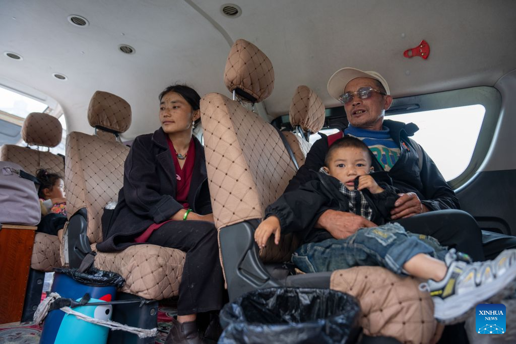 People take a vehicle and return home from a temporary relocation site in Gyirong Town, southwest China's Xizang Autonomous Region, Sept. 7, 2026. A fast-moving chain mudslide, triggered by a high-altitude glacier collapse in Nepal, struck Gyirong Port on the China-Nepal border in southwest China's Xizang Autonomous Region on Aug. 26, causing heavy casualties and leaving many missing. A barrier lake caused by the mudslide posed a serious threat to the lives and safety of the residents in the surrounding villages.
A total of 499 villagers were evacuated to Gyirong Town by the local authorities for their safety and experts were organized to carry out hidden danger investigations and hydrological monitoring to assess the risks of secondary disasters.
By far, the barrier lake on the upper reaches of the core affected zone of the mudslide-hit Gyirong Port has been drained. The local government has dispatched vehicles to transfer the affected people home in succession. On Monday, residents at the temporary relocation sites of Gyirong Town started returning home in an orderly manner. (Xinhua/Tenzing Nima Qadhup)