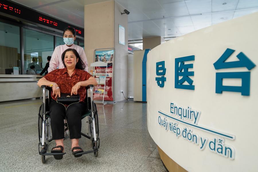 A staff member helps a Vietnamese patient in wheelchair at Remin hospital in Hekou Yao Autonomous County, southwest China's Yunnan Province, Feb. 28, 2026. (Xinhua/Peng Yikai)