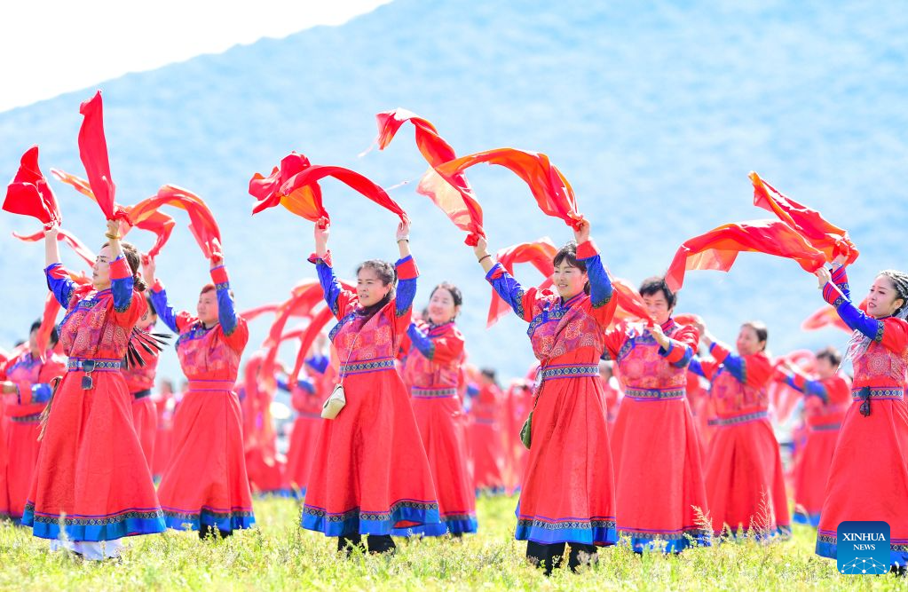 People perform at the opening ceremony of a Nadam fair in Jalaid Banner of Hinggan League, north China's Inner Mongolia Autonomous Region, Aug. 16, 2026. The Nadam fair opened here on Sunday, featuring equestrian performances, songs and dances, instrumental music and traditional folk performances. (Photo by Wang Zheng/Xinhua)