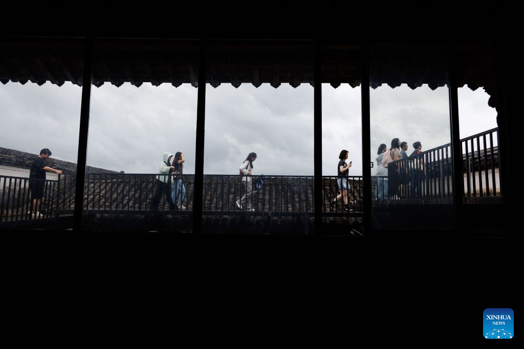 People visit Shi Ting Village in Yixian County, east China's Anhui Province, July 5, 2026. The ancient village of Shi Ting, located in the north of Yixian County in east China's Anhui Province, boasts of beautiful natural scenery and profound cultural heritage. (Xinhua/Jin Liwang)