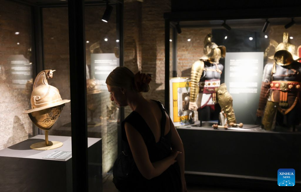 A woman visits the Colosseum during an official night tour program A Night at the Colosseum in Rome, Italy, July 28, 2026. (Xinhua/Wang Kaiyan)