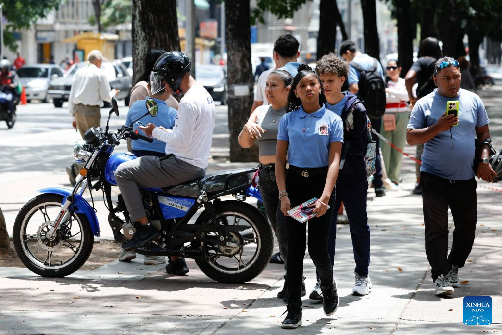 Students are pictured near a school, in Caracas, Venezuela, Sept. 14, 2026. More than 6 million Venezuelan students began the new school year on Monday, including those in La Guaira state in the country's north, which was hard hit by earthquake. (Photo by Marcos Salgado/Xinhua)