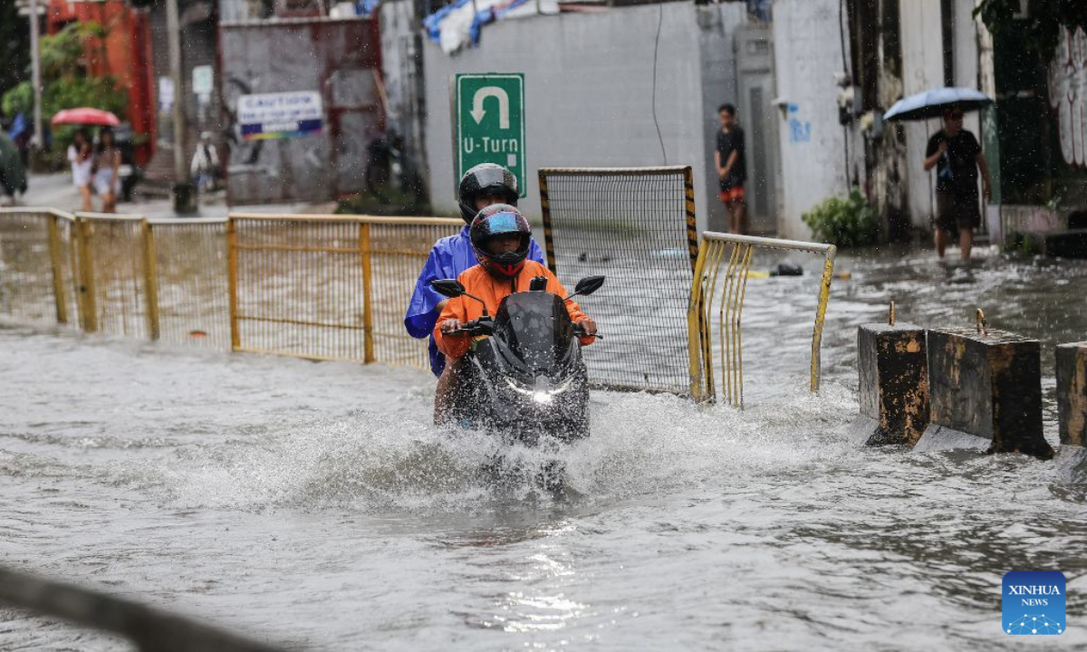 People ride a motorcycle through floodwater in Quezon City, the Philippines, on Aug. 17, 2026. The Philippine government has suspended in-person classes in Metro Manila and 12 other provinces as heavy rains from tropical cyclones and the southwest monsoon continue to batter the country, local media reported on Monday.
The extreme rainfall has triggered severe flooding and landslides across the nation. The well-known flood-control corruption scandal has left key infrastructure unfinished or poorly maintained, further straining the country's disaster response, local media reported. (Xinhua/Rouelle Umali)