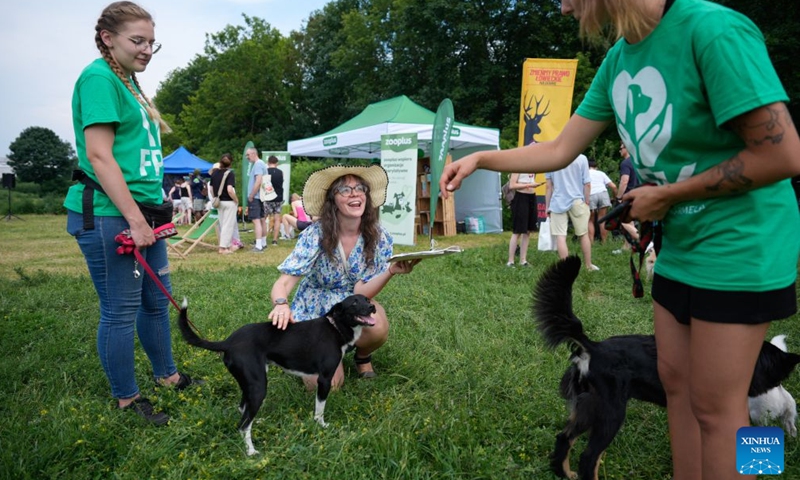 People attend an event marking the Warsaw Animal Day at a park in Warsaw, Poland, June 21, 2026. (Photo by Jaap Arriens/Xinhua)