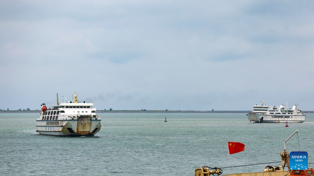 Passenger and freight ferries are pictured at Xiuying Port in Haikou, south China's Hainan Province, Aug. 26, 2026. The passenger and freight ferry services across the Qiongzhou Strait have resumed in an orderly manner on Wednesday afternoon as the impact of Typhoon Narra gradually weakened. (Xinhua/Yang Guanyu)