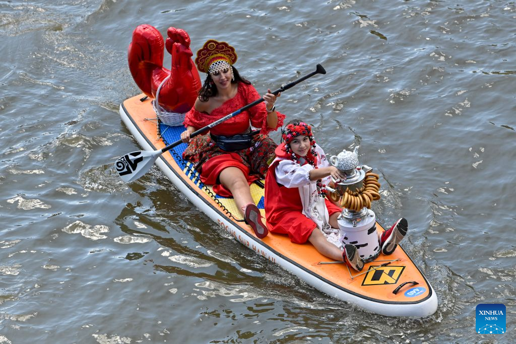 People take part in the annual Yauzafest paddleboarding festival in Moscow, Russia, on Aug. 9, 2026. (Photo by Alexander Zemlianichenko Jr/Xinhua)