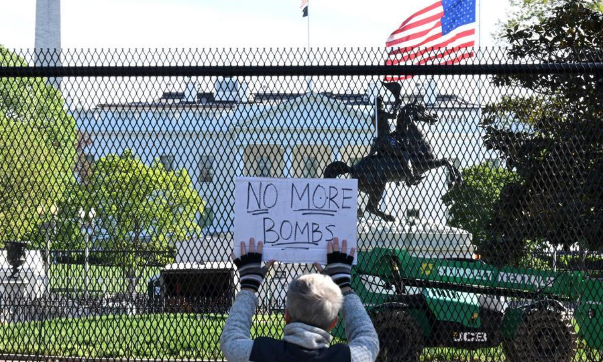 A demonstrator holds a placard in front of the White House in Washington, D.C., the United States, on April 7, 2026. (Xinhua/Li Rui)