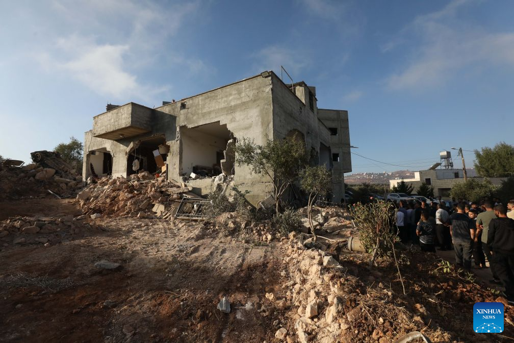 Palestinians inspect a building after the Israeli forces destroyed it, in the town of Aqraba, south of Nablus in the West Bank, on Sept. 8, 2026. A Palestinian man was killed by Israeli army fire on Tuesday in the town of Aqraba, south of Nablus in the northern West Bank. (Photo by Nidal Eshtayeh/Xinhua)