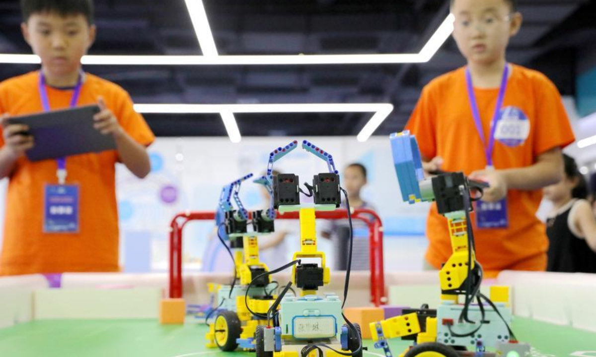 Children participate in a robot football competition in Jiyuan City, central China's Henan Province, Aug. 15, 2026. (Photo by Duan Erping/Xinhua)