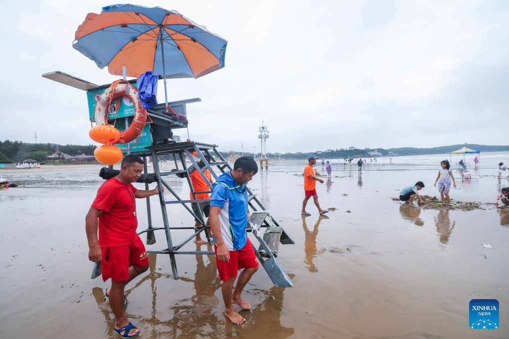 Staff members put a lifeguard stand in place at the Nansha scenic area in Zhujiajian of Zhoushan City, east China's Zhejiang Province, Aug. 12, 2026.
The Nansha scenic area reopened to the public on Wednesday following necessary safety checks and maintenance after Typhoon Dolphin weakened. (Xinhua/Xu Yu)