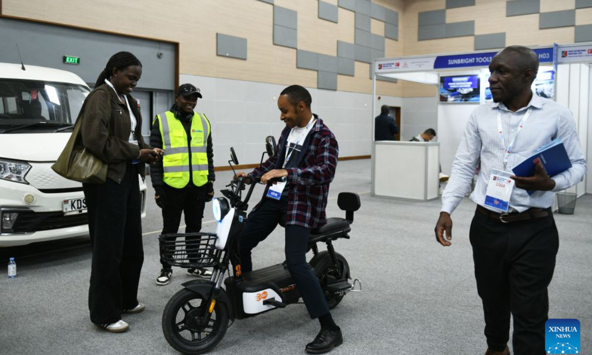 A visitor tries an electric bike exhibited by a Chinese enterprise at the 9th Kenya International Industrial Expo in Nairobi, Kenya, Sept. 3, 2026. (Xinhua/Liu Qiong)