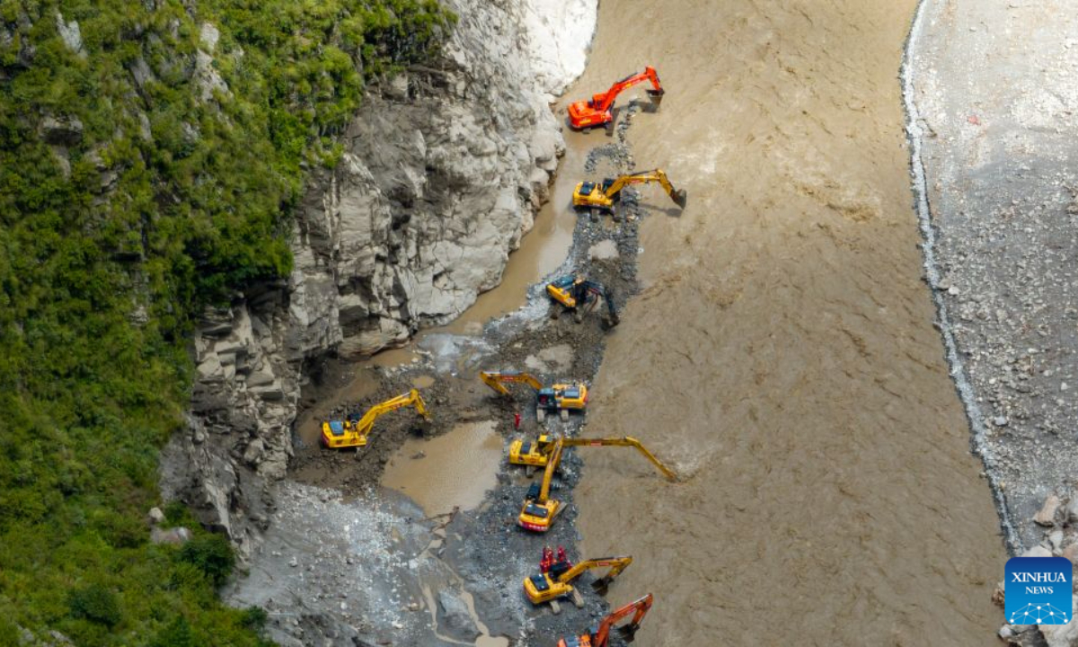 An aerial drone photo shows a road clearance operation underway in a section of the G216 national highway from Gyirong Town to Gyirong Port in southwest China's Xizang Autonomous Region, on Aug. 30, 2026. China Anneng, a state-owned engineering and rescue enterprise, continued its rescue work on Sunday in an attempt to restore the last few kilometers of damaged section of the G216 national highway leading to Gyirong Port. (Xinhua/Jigme Dorje)