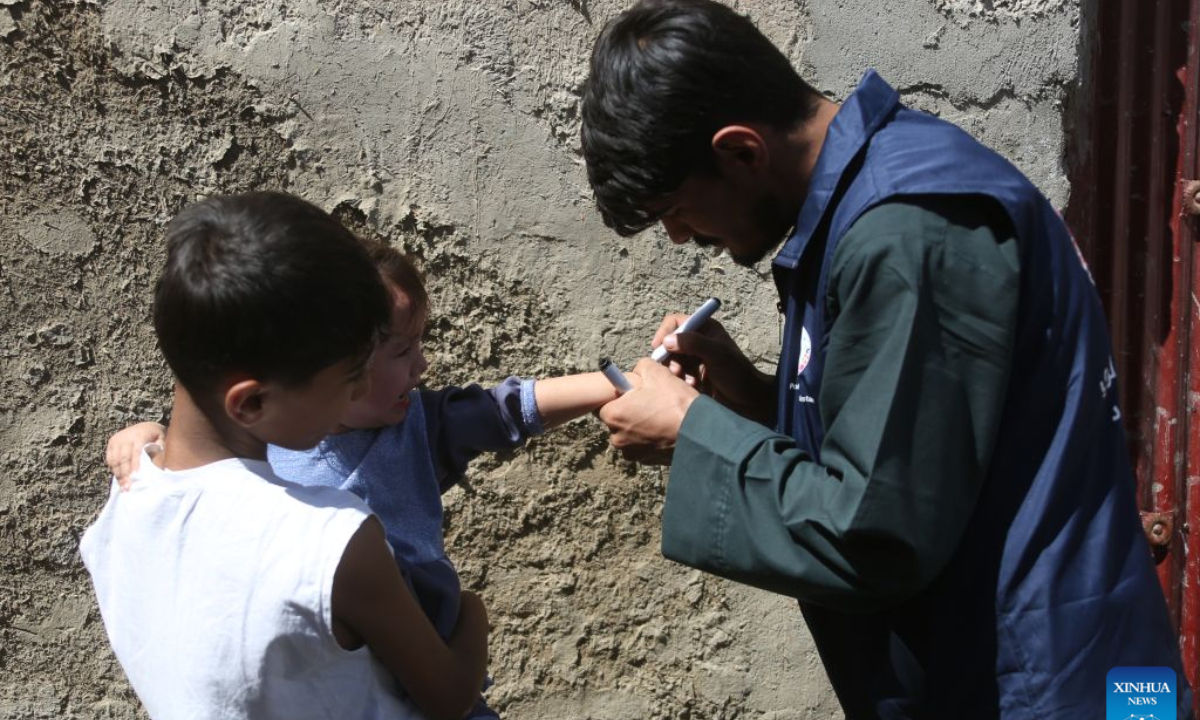 A health worker gives a dose of polio vaccine to a child during a polio vaccination campaign in Kabul, Afghanistan, Sept. 21, 2026. Afghanistan's Ministry of Public Health on Monday launched a nationwide polio vaccination campaign aimed at immunizing more than 12.7 million children under the age of five against the poliovirus. (Photo by Saifurahman Safi/Xinhua)