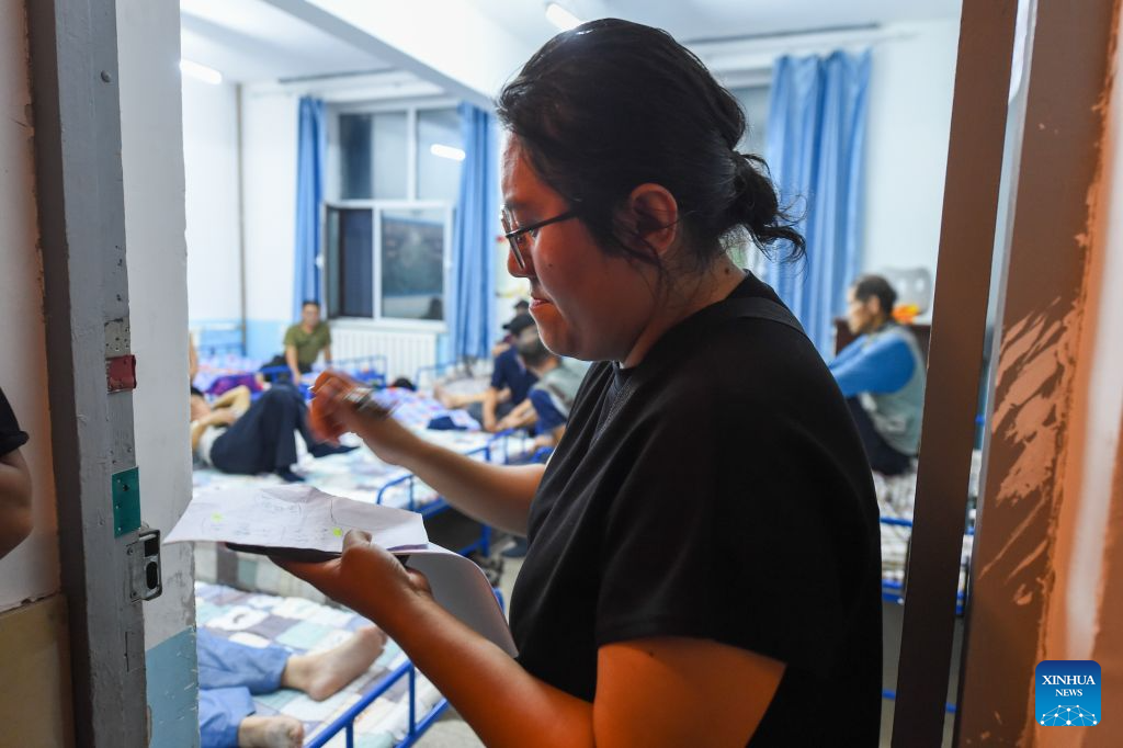A staff member registers residents' information at a temporary shelter in Xinxing Village, Dongguang Town, Wangqing County, northeast China's Jilin Province, July 29, 2026. Heavy rainfall has caused flood in Wangqing and trapped residents. Local authorities have carried out emergency rescue and response. (Xinhua/Zhang Nan)