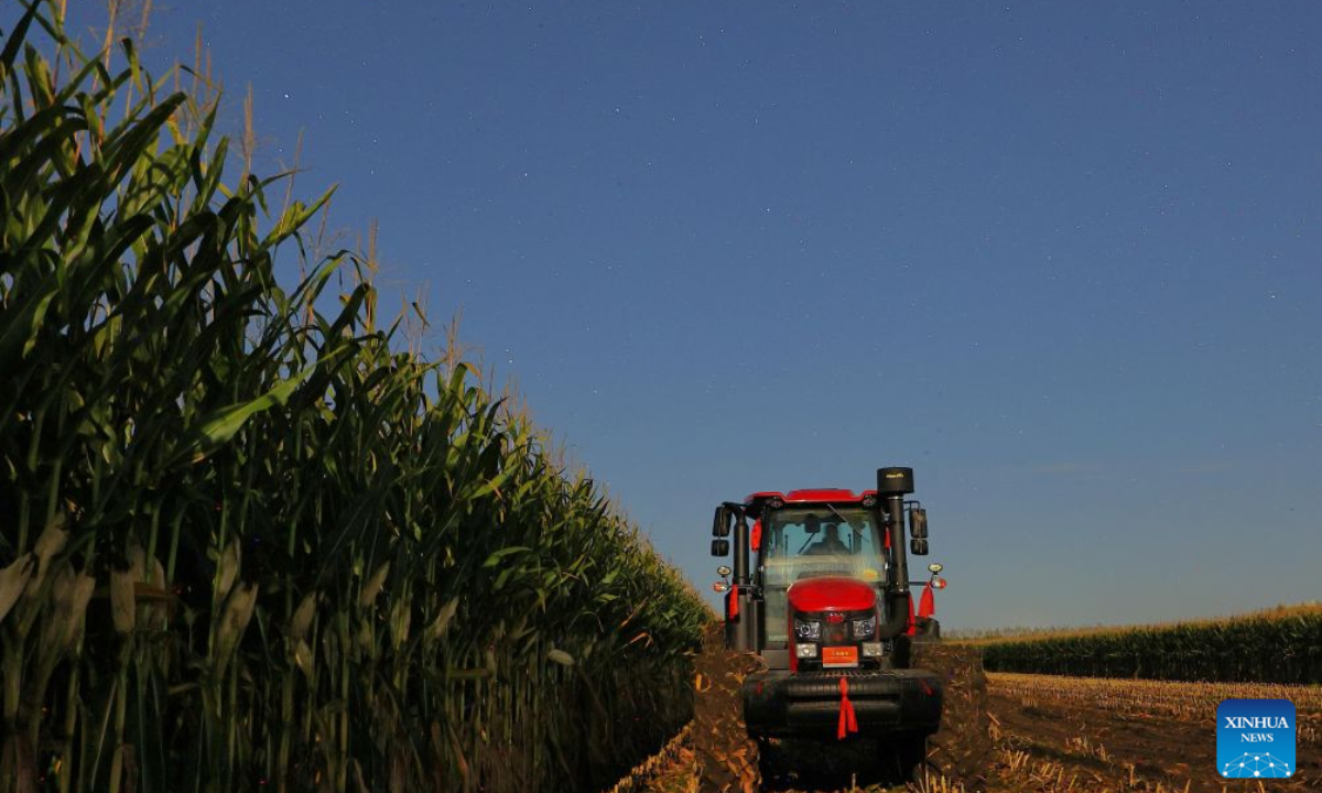 This photo taken on Sept. 21, 2026 shows agricultural machinery in a corn field under starry sky in Baiquan County, northeast China's Heilongjiang Province.