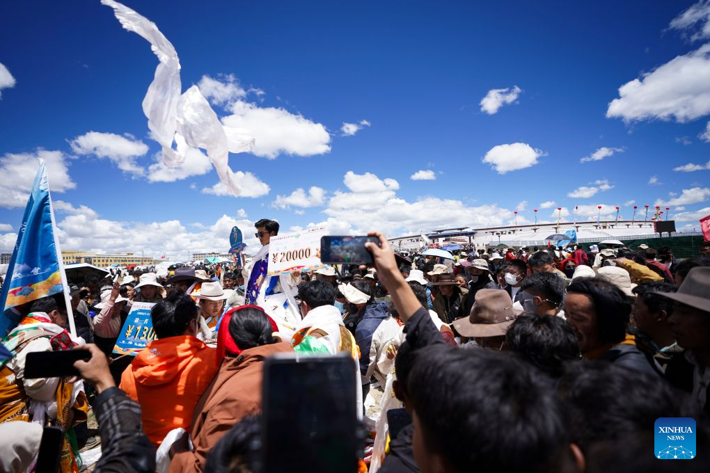 Champion rider and horse are congratulated after winning the invitational 12,000m walking race of famous horse at the Nagqu Horse Racing Festival 2026 at Gesar Racecourse in Nagqu, southwest China's Xizang Autonomous Region, Aug. 10, 2026. Featuring traditional equestrian contests, ethnic sports performances and trade fair, the event kicked off here on Monday, drawing large crowds of locals and visitors. (Xinhua/Hu Xingyu)