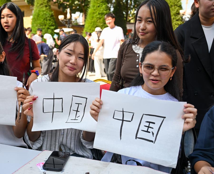 Students try Chinese calligraphy at the Confucius Institute at the Osh State University in Osh, Kyrgyzstan, Sept. 22, 2026. (Xinhua/Jiang Youlin)