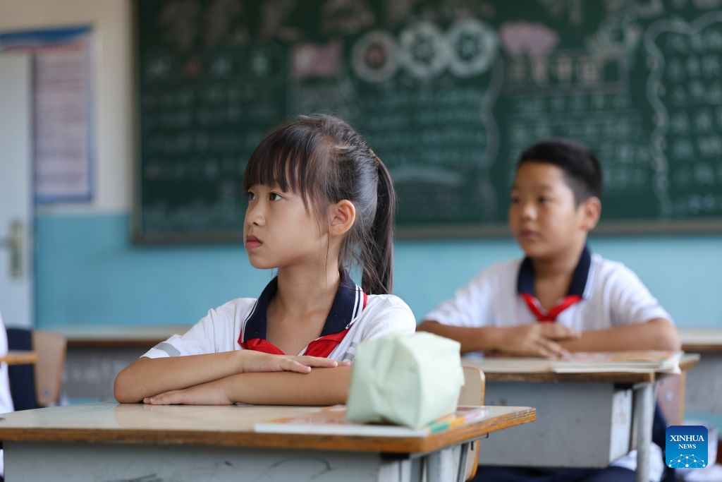 Students listen to a lecture at Hongshuizhuang central primary school Sangyuan branch in Luozhuangzi Town of Tianjin, north China, Sept. 1, 2026. The school, located at the foot of the Yanshan Mountains, has only 28 students coming from three surrounding villages of Sangyuan, Nihe and Shangbaiyu, and is the primary school with the fewest students in Jizhou District. On the first day of the new semester, it held a flag-raising ceremony after the students had their first classes of the new semester. (Xinhua/Li Ran)