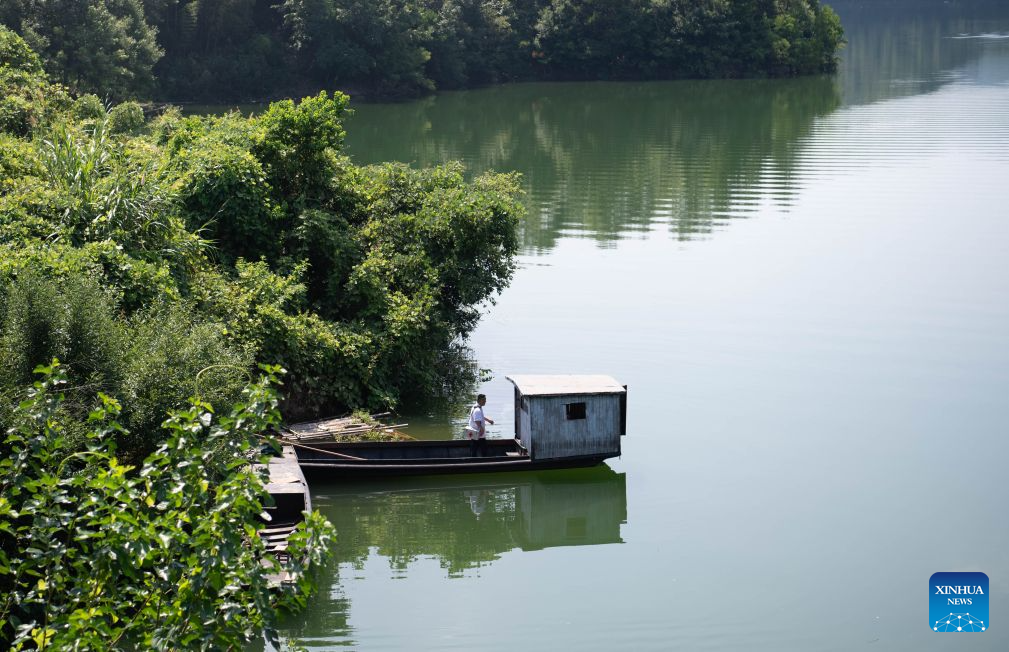 Doctor Yu Jiajun prepares to leave by boat after a home visit in Qishan Village of Mabu Town, Jinzhai County of Lu'an City, east China's Anhui Province, Aug. 4, 2026. Haidao Village of Qishan Village is located deep in the mountains near the Xianghongdian Reservoir area in Jinzhai County of Lu'an City, east China's Anhui Province. Yu Jiajun, the only village doctor, takes charge of health care for more than 500 villagers there and in the surrounding areas. (Xinhua/Zhang Duan)