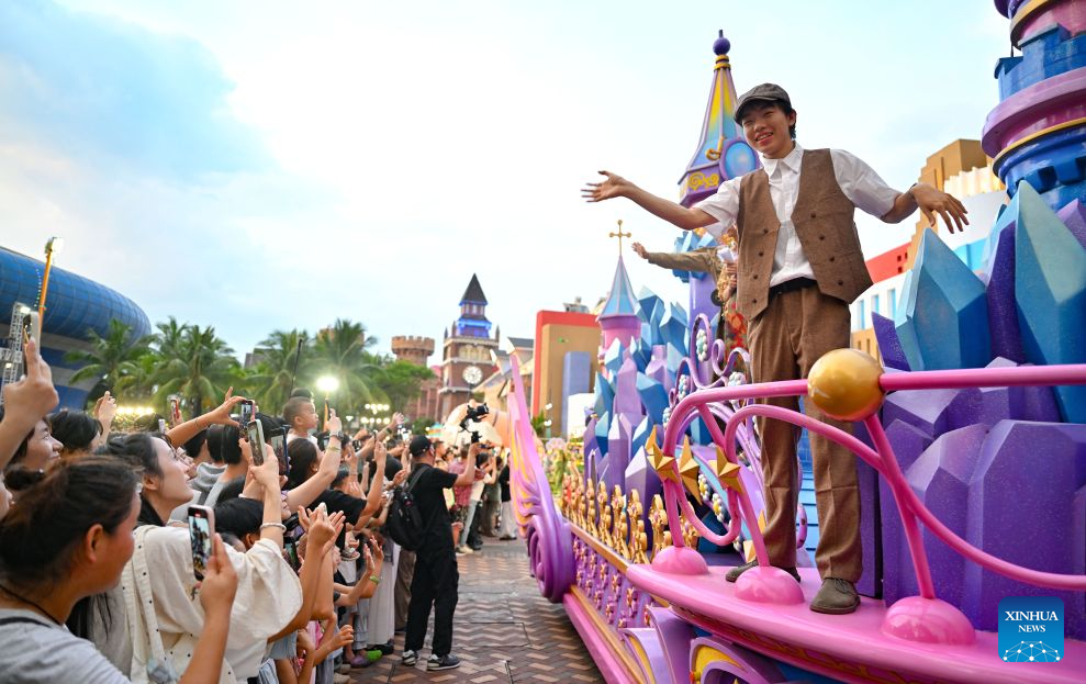 Tourist watch a parade during a carnival held at a themed park in Haikou, south China's Hainan Province, July 18, 2026. Hainan is seeing a surge in visitors during the summer holiday season. (Xinhua/Guo Cheng)