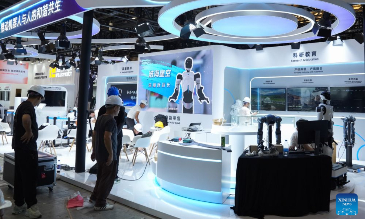 Workers arrange exhibition stalls at the Shanghai World Expo Exhibition and Convention Center in Shanghai, east China, July 16, 2026. Shanghai is ushering in its major AI moment of the year with the forthcoming 2026 World AI Conference (WAIC) and High-Level Meeting on Global AI Governance, scheduled from Friday to Monday. Themed