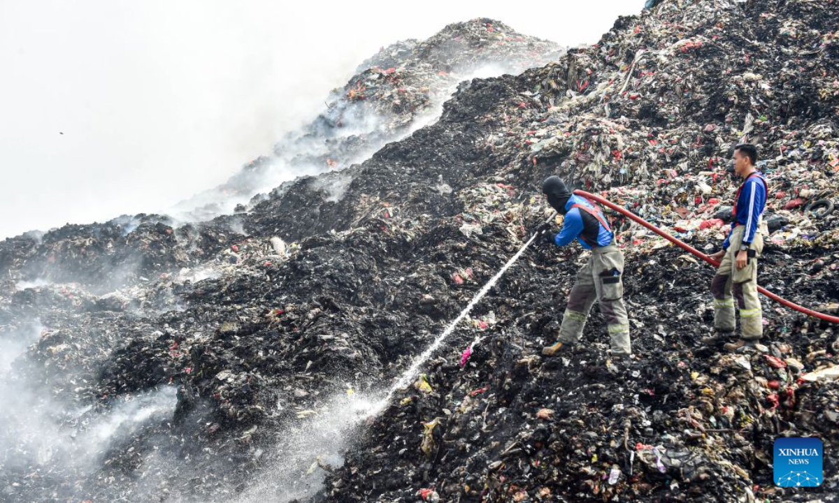 Firefighters attempt to put out a fire at the smoldering landfill in Tangerang Regency, Banten Province, Indonesia, on July 2, 2026. A fire broke out at a landfill in Tangerang regency, near the Indonesian capital city of Jakarta, on Tuesday, scorching more than two hectares of land, local officials said. (Xinhua/Agung Kuncahya B.)