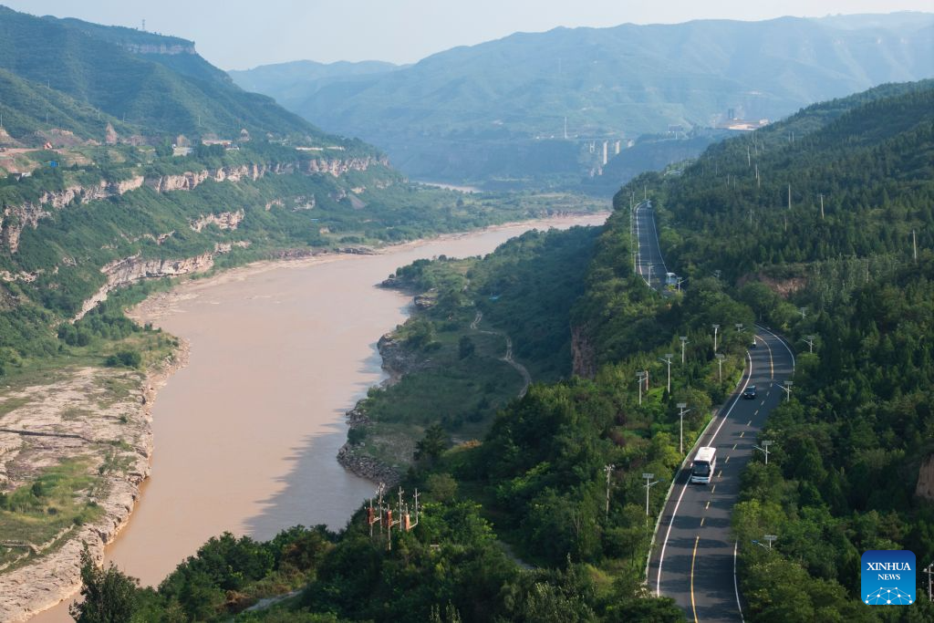 An aerial drone photo taken on Aug. 10, 2026 shows a view of the Yanhuang Highway along the Yellow River in northwest China's Shaanxi Province. With the completion and operation of transport infrastructure, such as the Yanhuang Highway in northwest China's Shaanxi Province and the Yellow River No.1 Tourist Highway in north China's Shanxi Province, tour along the Yellow River has become a popular choice for many travelers in summer. (Xinhua/Shao Rui)