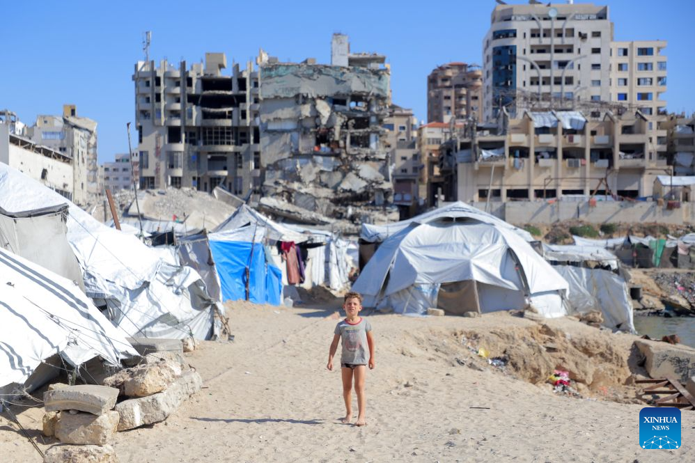 A child is seen at a makeshift tent camp in Gaza City, Oct. 7, 2026. The latest round of Gaza conflict marks its third anniversary on Wednesday. (Photo by Rizek Abdeljawad/Xinhua)