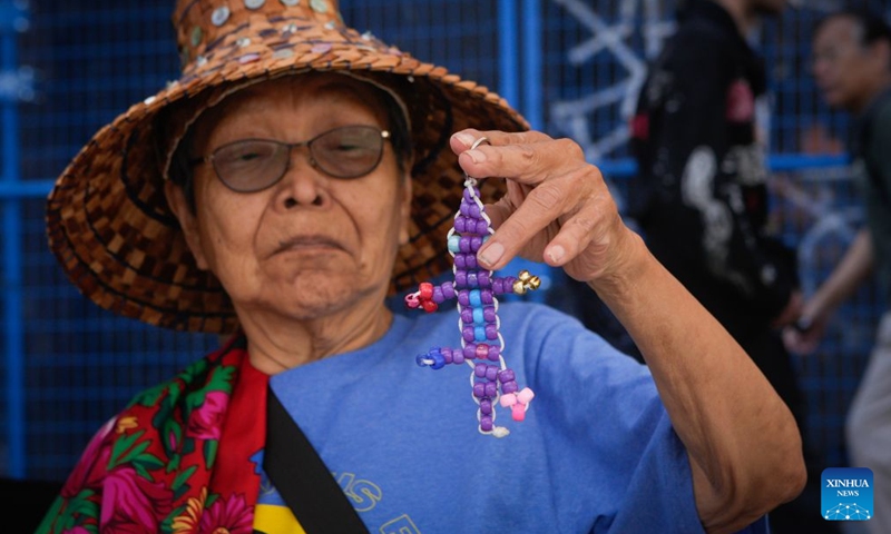 An Indigenous elder displays a traditional beadwork during a National Indigenous Peoples Day event in Vancouver, British Columbia, Canada, June 21, 2026. (Photo by Liang Sen/Xinhua)