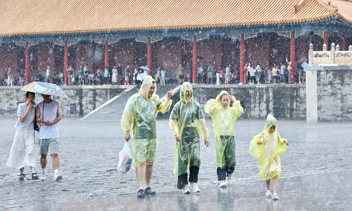 Visitors toured the Palace Museum during heavy rain after a sudden downpour in Beijing on August 2, 2026. Photo: VCG