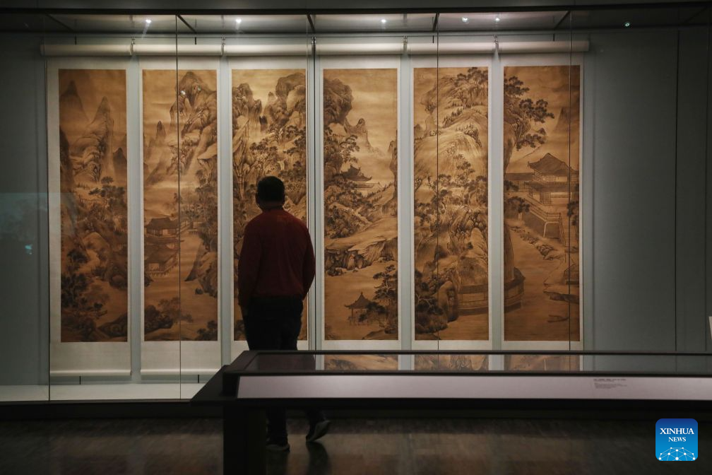 A visitor views an exhibit at an exhibition named The Mountains of the Mind: A Chinese Landscape Journey at the Asian Art Museum in San Francisco, the United States, Sept. 19, 2026. The exhibition, featuring over 20 paintings, runs from December 13, 2025 to October 26, 2026. (Photo by Liu Yilin/Xinhua)