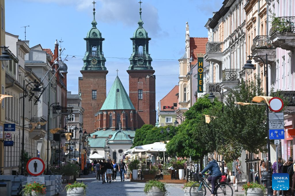 People walk on a street in Gniezno, Poland, Aug. 11, 2026. Gniezno is one of Poland's oldest cities and is known for its rich history and cultural heritage. (Photo by Aleksy Witwicki/Xinhua)