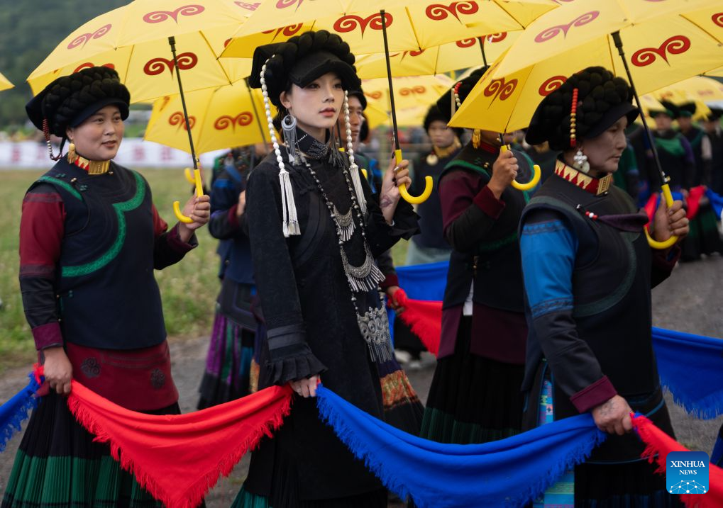 People of the Yi ethnic group in traditional costumes perform singing and dancing in Xinhua Village, Yuexi County of southwest China's Sichuan Province, Aug. 3, 2026.(Xinhua/Jiang Hongjing)