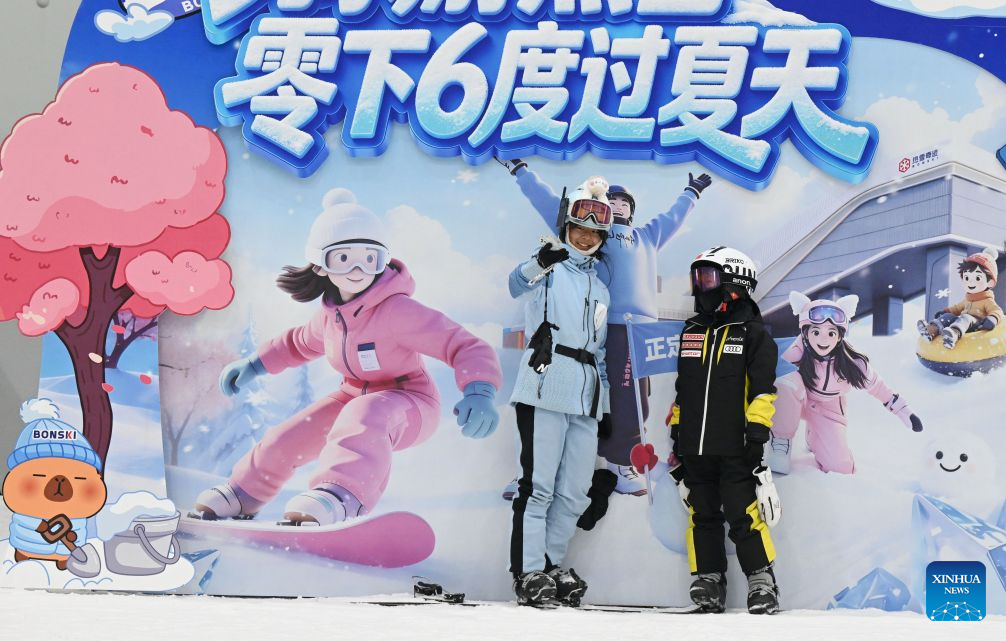 People have fun at an indoor ski resort in Shijiazhuang, north China's Hebei Province, July 21, 2026. The city of Shijiazhuang has been focusing on developing its ice-and-snow economy during summers in recent years. A number of indoor ski resorts across the city have rolled out consumption subsidies and hosted professional competitions to develop a heat-relief business model. (Photo by Chen Qibao/Xinhua)
