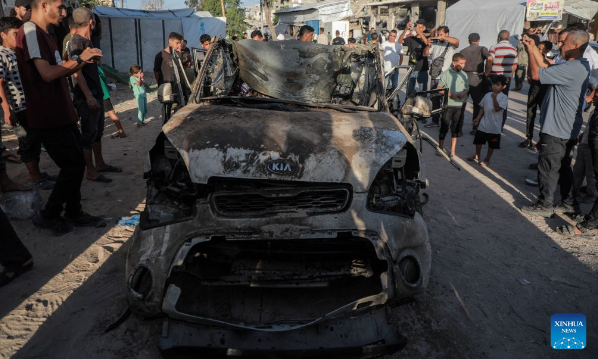 Palestinians gather around a burned vehicle following an Israeli drone strike targeting a civilian vehicle, in the Tel al-Hawa area west of Gaza City, Oct. 8, 2026. Two Palestinians were killed and several others injured Thursday in an Israeli strike targeting a vehicle west of Gaza City, according to medical and local sources. (Photo by Rizek Abdeljawad/Xinhua)