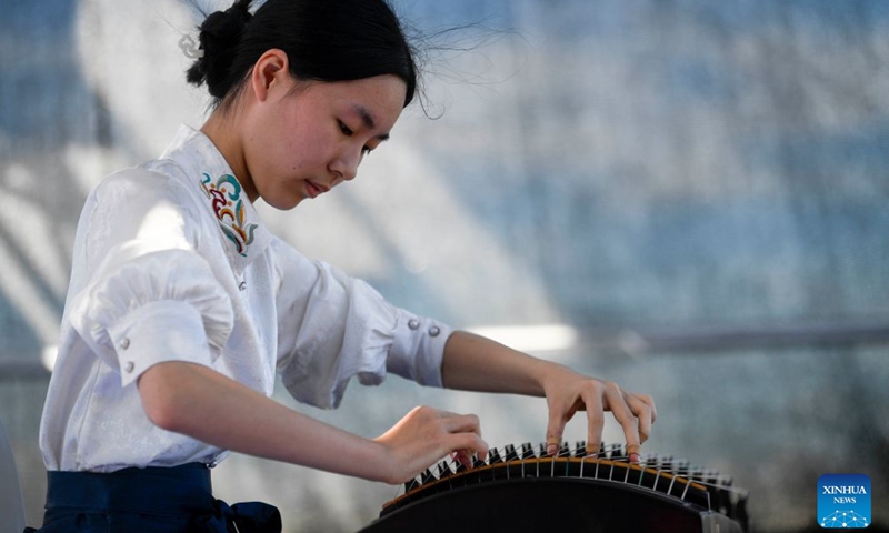 An artist plays Guzheng, a traditional Chinese musical instrument also known as Chinese plucked zither, during a cultural event marking the Dragon Boat Festival at Lagoa Rodrigo de Freitas in Rio de Janeiro, Brazil, June 20, 2026. (Photo by Daniel Ramalho/Xinhua)