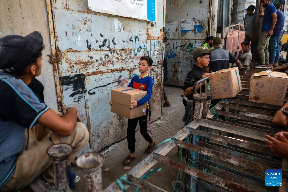 Palestinians receive food rations through the World Food Programme from one of its distribution centers in the Al-Tuffah area east of Gaza City, on Sept. 15, 2026. (Photo by Rizek Abdeljawad/Xinhua)