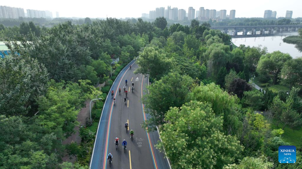An aerial drone photo taken on July 22, 2026 shows cycling enthusiasts riding in Xingtai City, north China's Hebei Province. Xingtai City is a nationally renowned bicycle manufacturing base, with its products sold worldwide. In recent years, Xingtai has pushed forward the upgrading of the bicycle industry, continuously improved cycling infrastructure, and hosted a wide range of professional cycling races and mass public riding events. By integrating manufacturing and cycling events, the city has fueled accelerated growth of the local bicycle sector. (Photo by Feng Yichao/Xinhua)